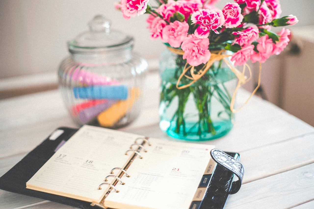 Calendar and Planning Image of a daily calendar on a table with fresh flowers