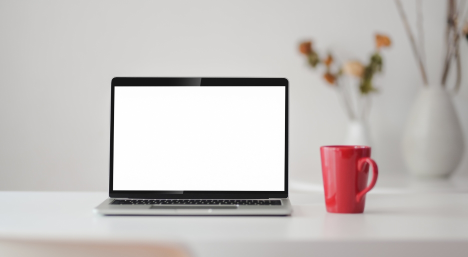 Making Alimony Payments Online This is an image of a laptop on a table with a cup of coffee.