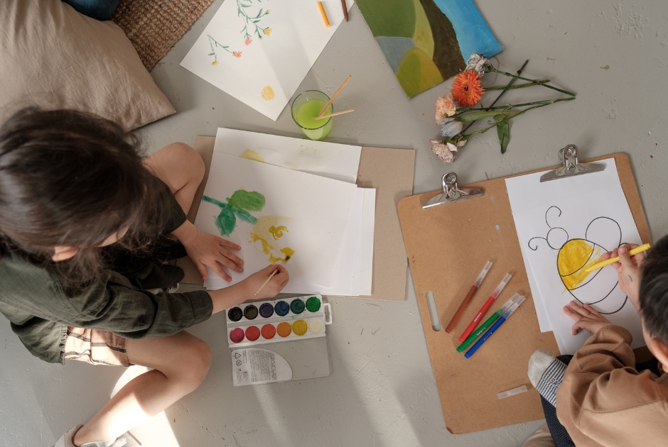 Prioritizing Children's Well-being This is an image of several children making artwork.