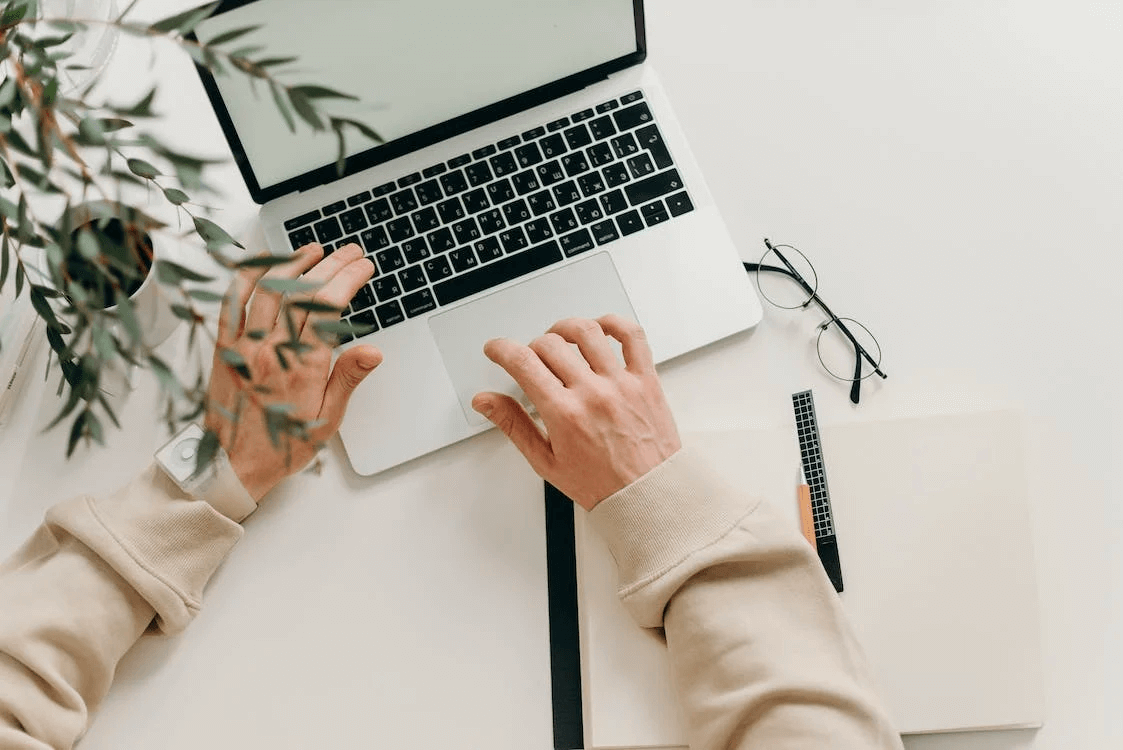 Researching on a Laptop Image of a person's hands on a laptop computer