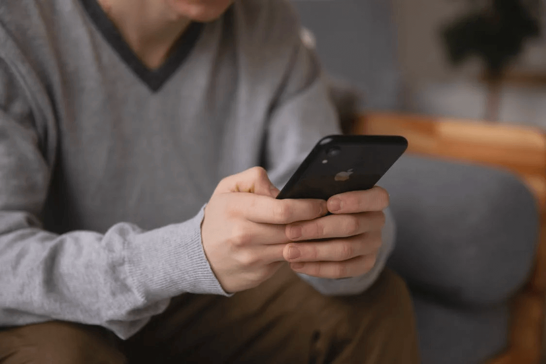 Researching on a Smartphone Image of a person holding an iPhone