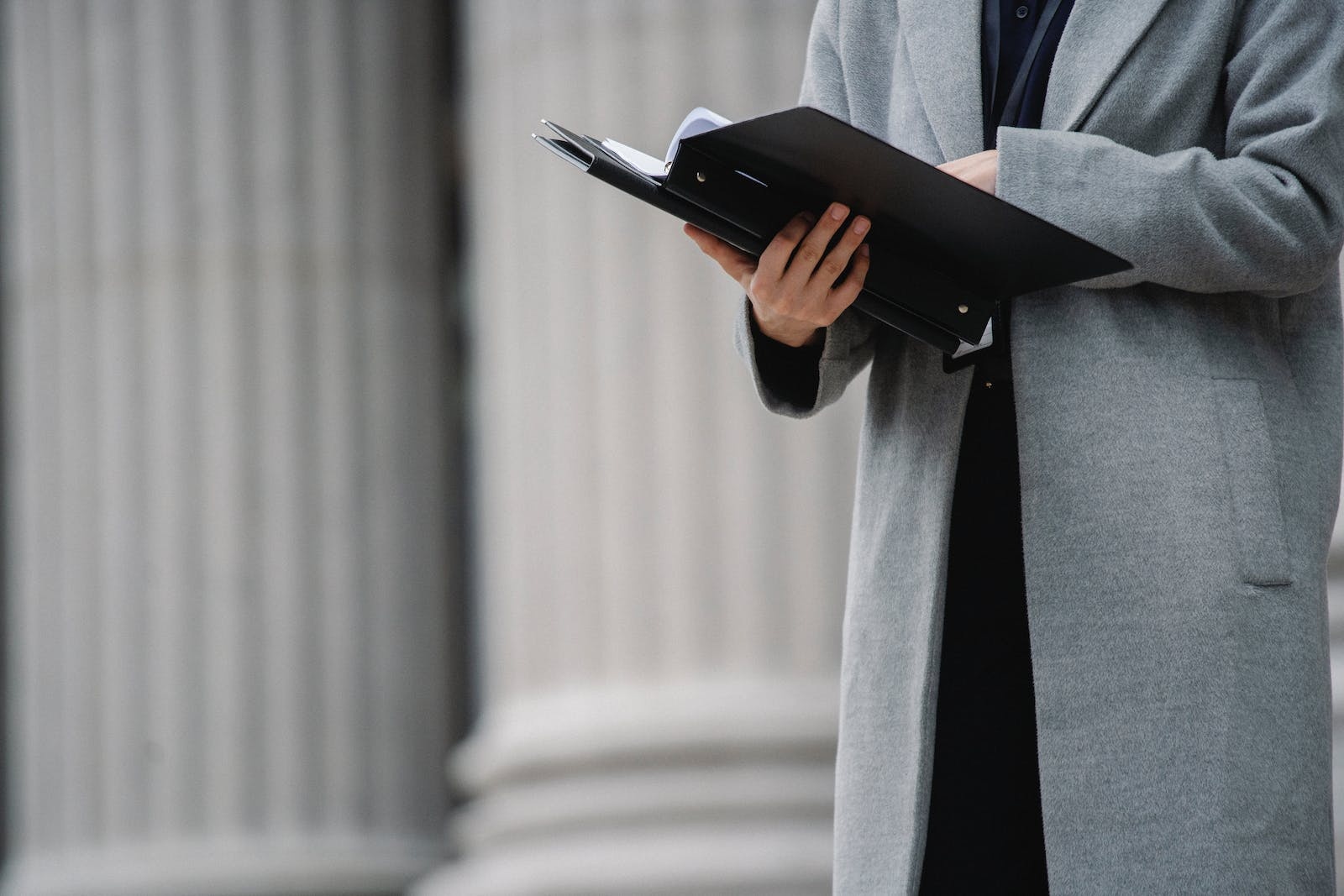 This is an image of a person reading from a document.