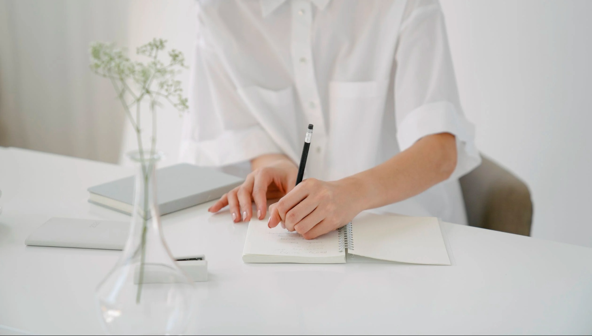 This is an image of a person taking notes about contested and uncontested divorce in Colorado.