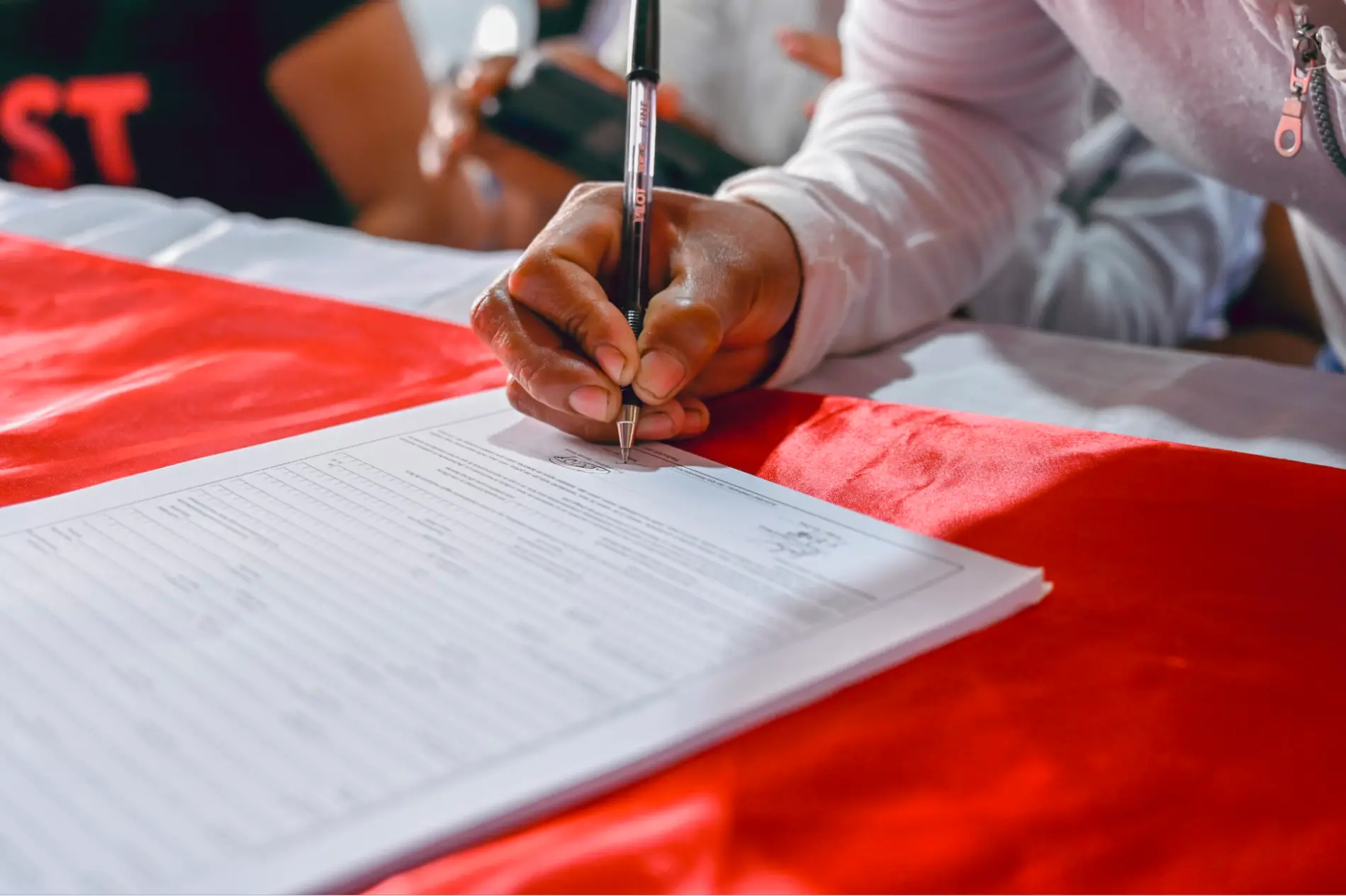 This is an image of a person signing a document.