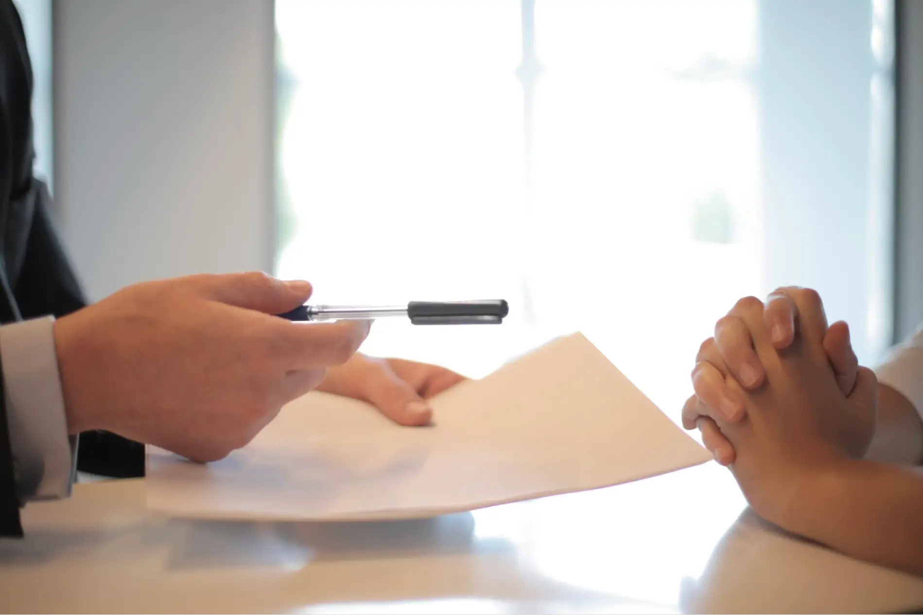 Legal Documents This is an image of a person asking another person to sign legal documents.