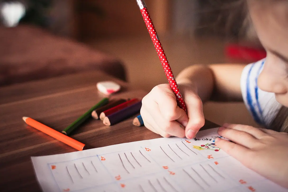 This is an image of a child working on a drawing.