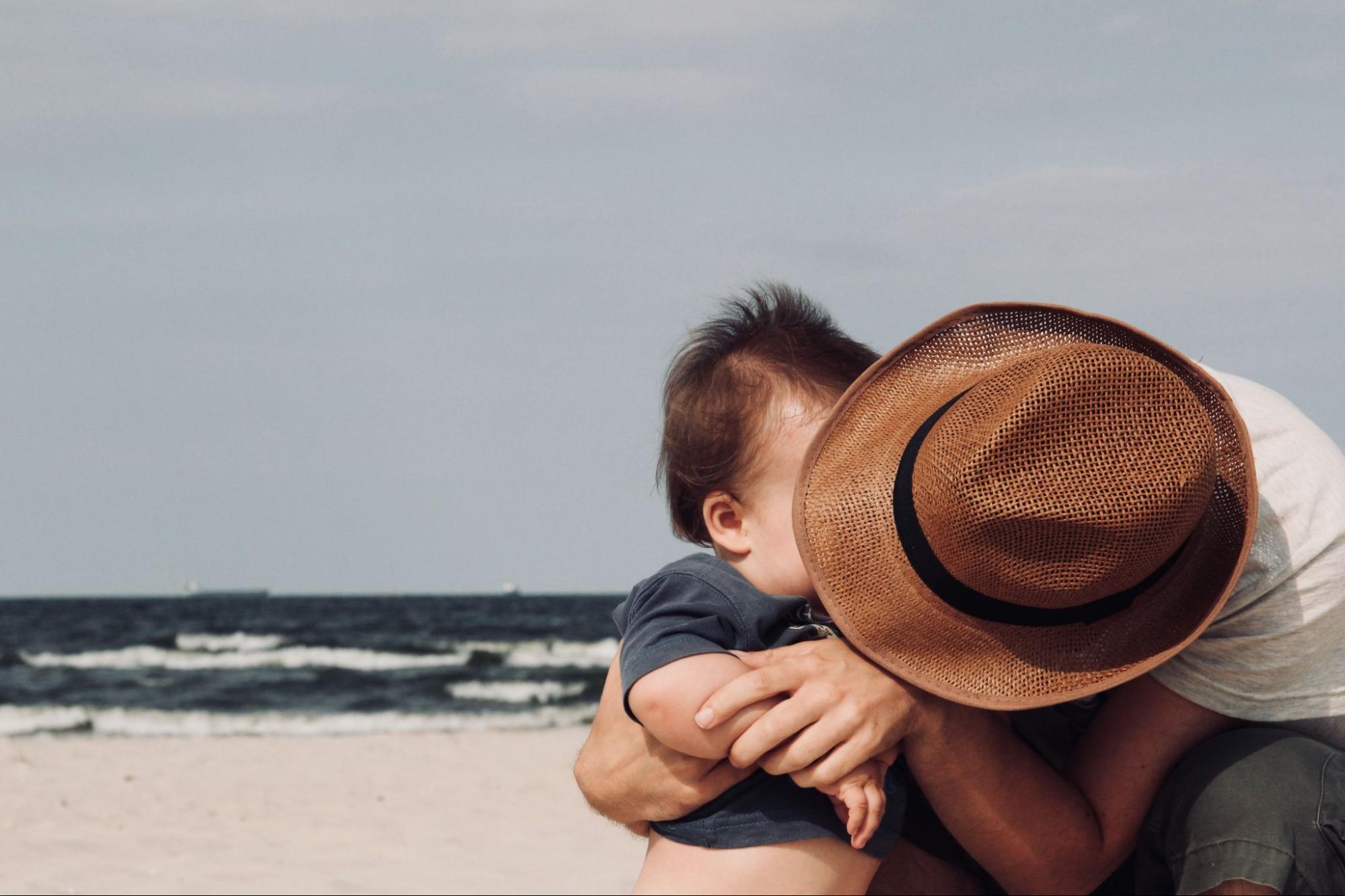 Peaceful Resolution This is an image of a father and son embracing on a beach.