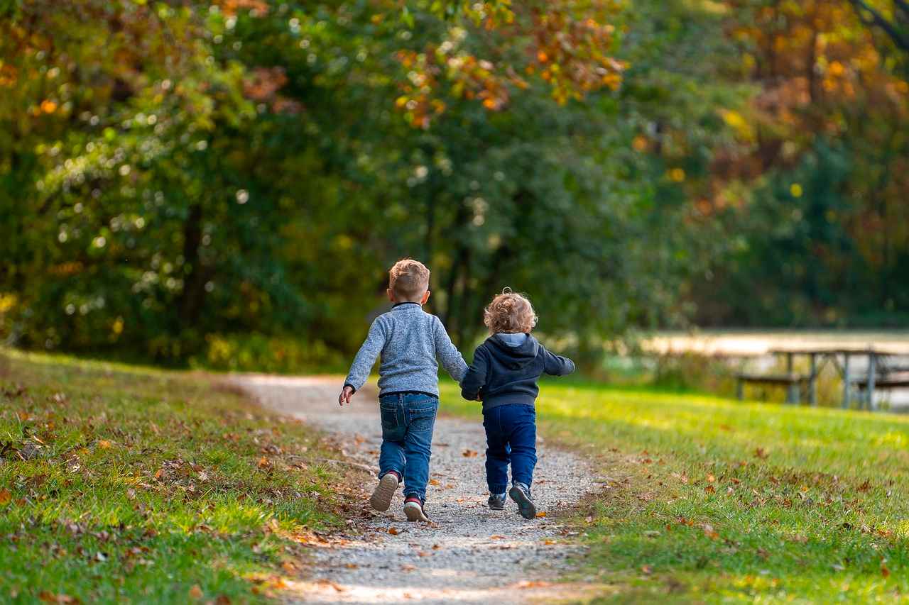 Two Contented Siblings Siblings holding hands while on a walk