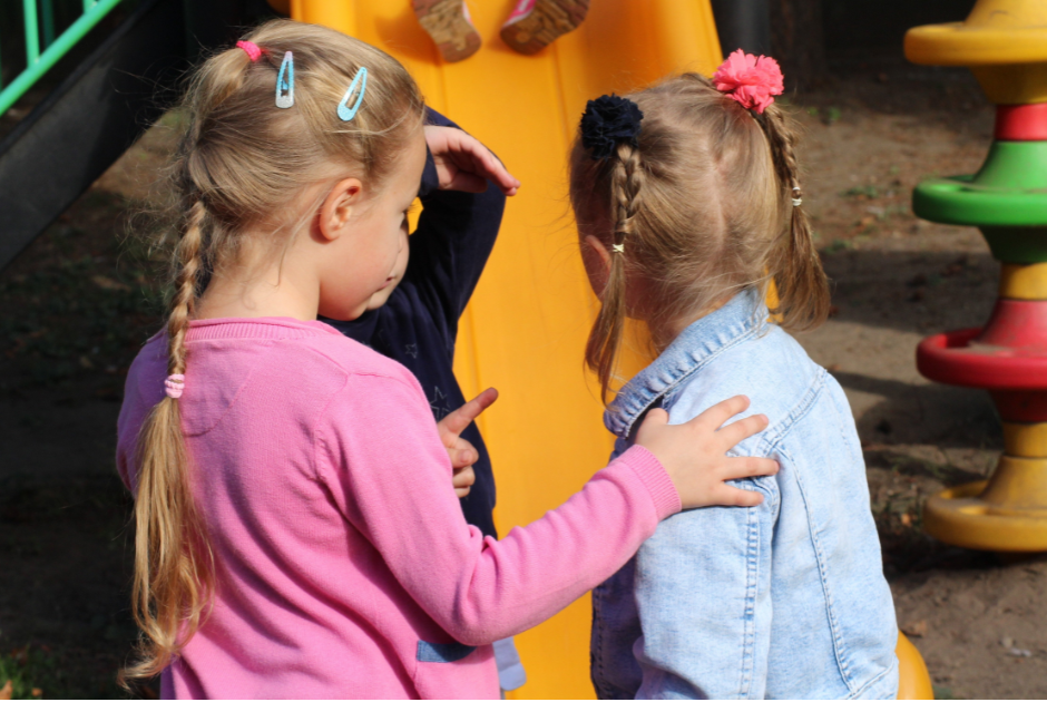 This is an image of two children on a playground.