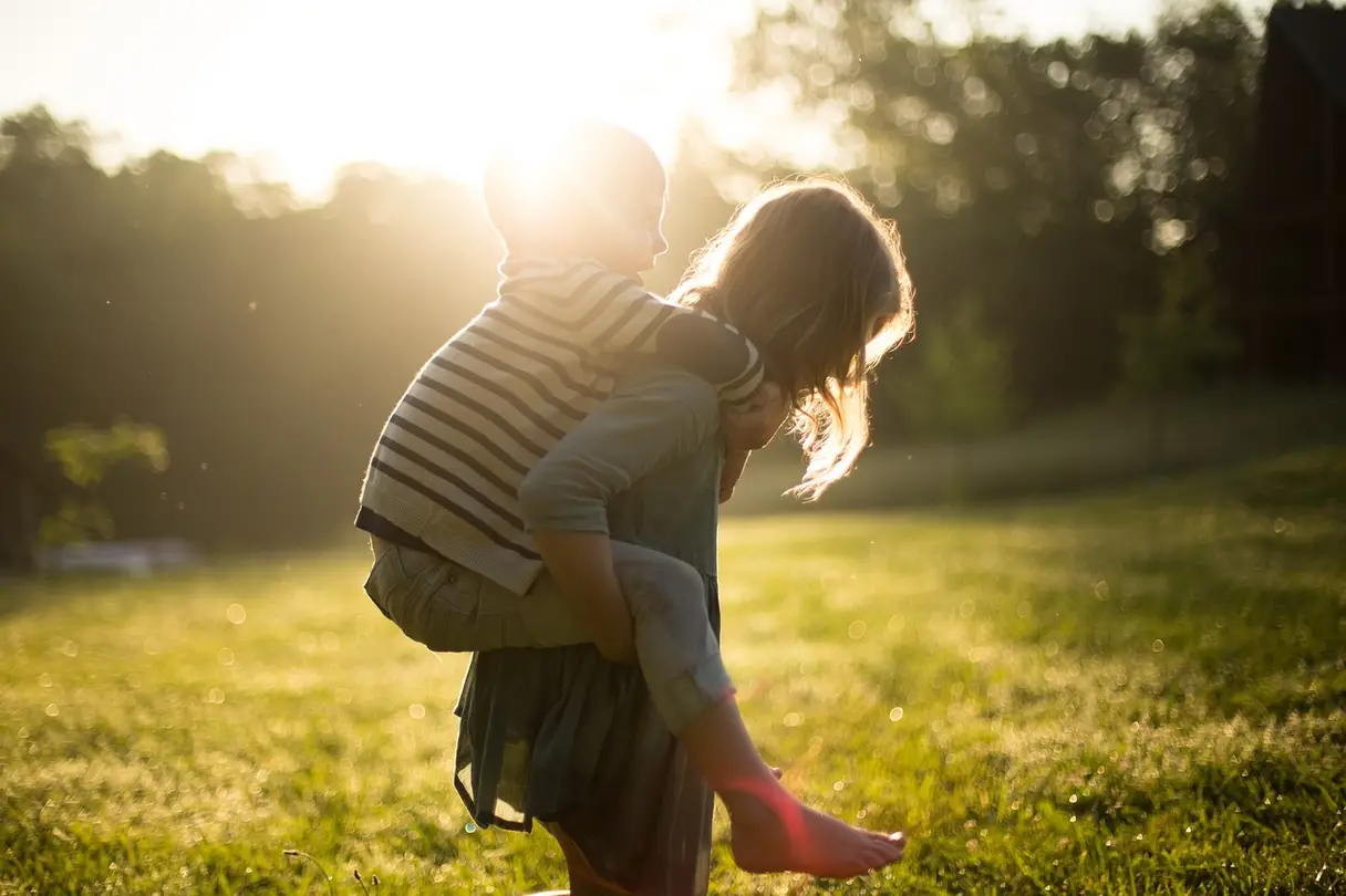 This is an image of a parent giving their child a piggyback ride.